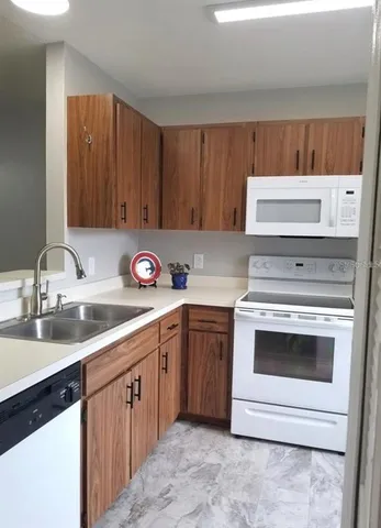 a kitchen with a sink and a stove top oven
