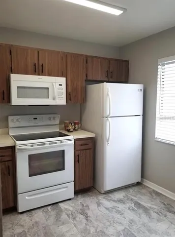 a white refrigerator freezer sitting in a kitchen