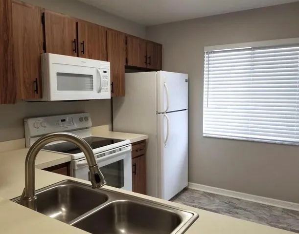 a kitchen with a sink a cabinets and window