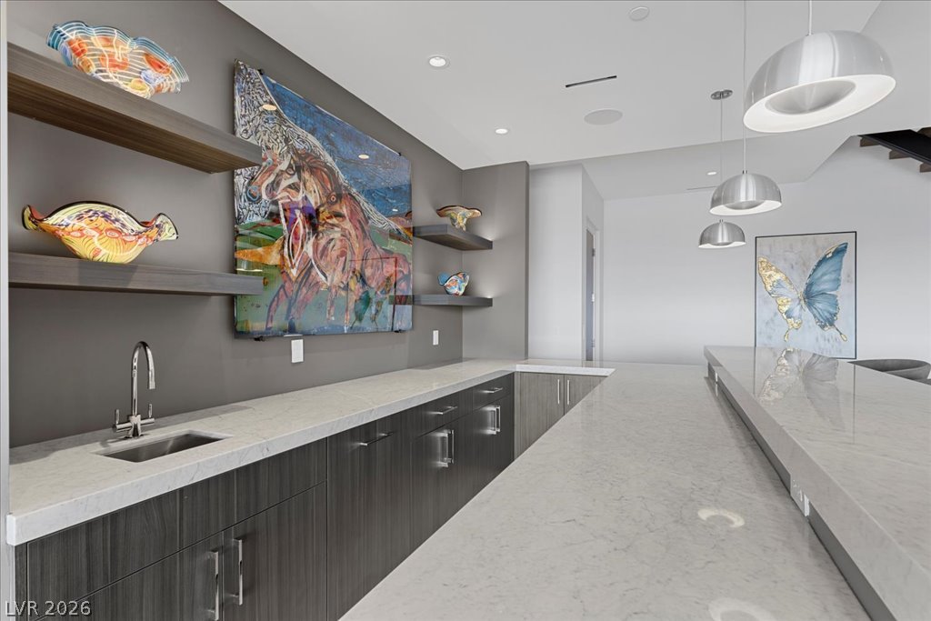 657 Ridgestone Rim Court Henderson, NV 89012 - Photo 61 of 97 Polished stone countertops pair with contemporary cabinetry along this sleek service bar.