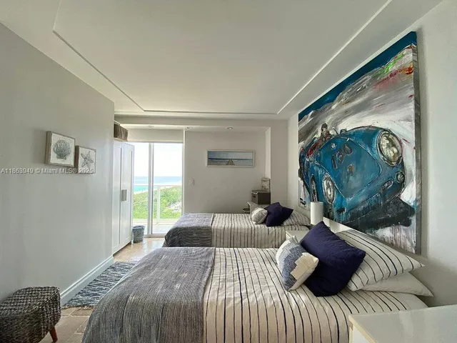 a bedroom with a bed and a painting on the wall