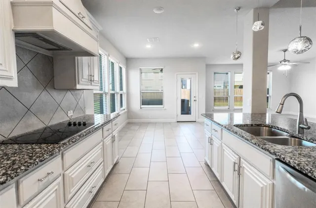 a kitchen with a sink and cabinets