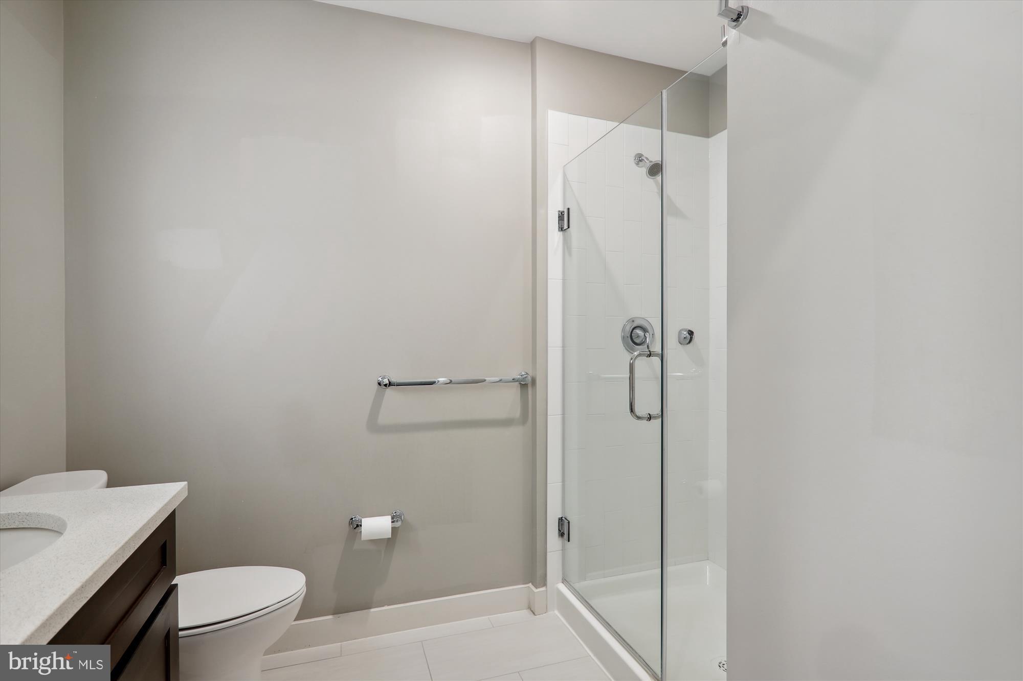 1320 Fenwick Lane, Unit 312 Silver Spring, MD 20910 - Photo 23 of 44 a bathroom with a shower a toilet and sink
