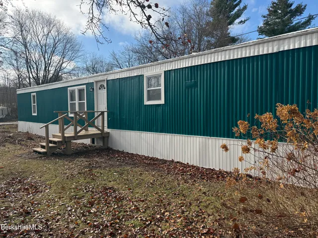 a view of a backyard with a table and chairs
