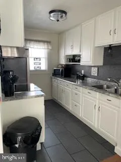 a kitchen with stainless steel appliances a stove a sink a refrigerator and cabinets