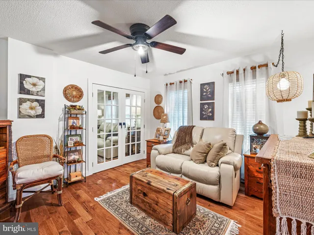 a living room with furniture a rug and a window