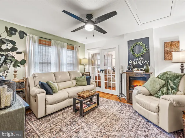 a living room with furniture ceiling fan and a rug