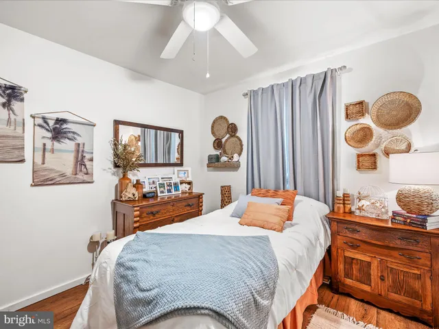 a bedroom with a bed and dresser with mirror