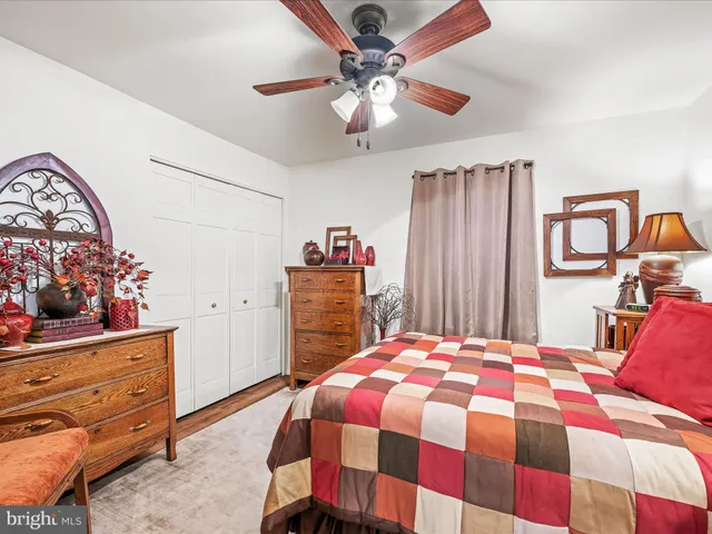 a bedroom with a bed and a dresser in it