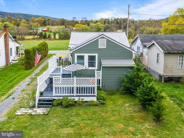 a view of a house with a yard and deck