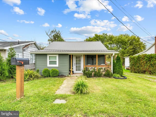 a front view of a house with a yard and porch
