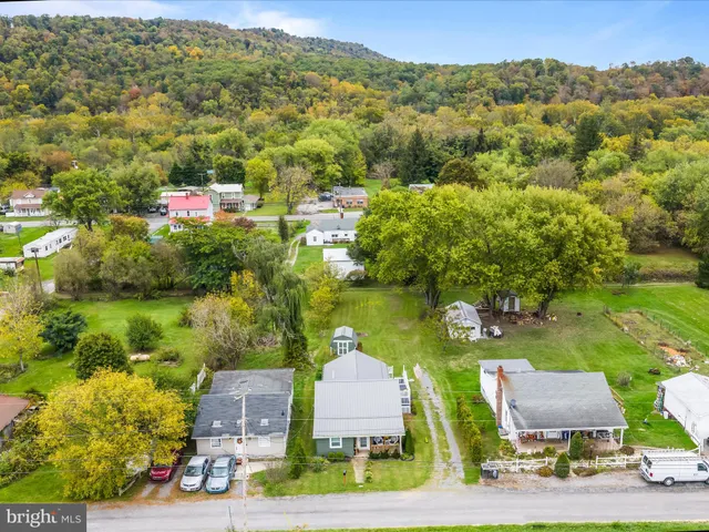 an aerial view of a house with garden space and outdoor seating