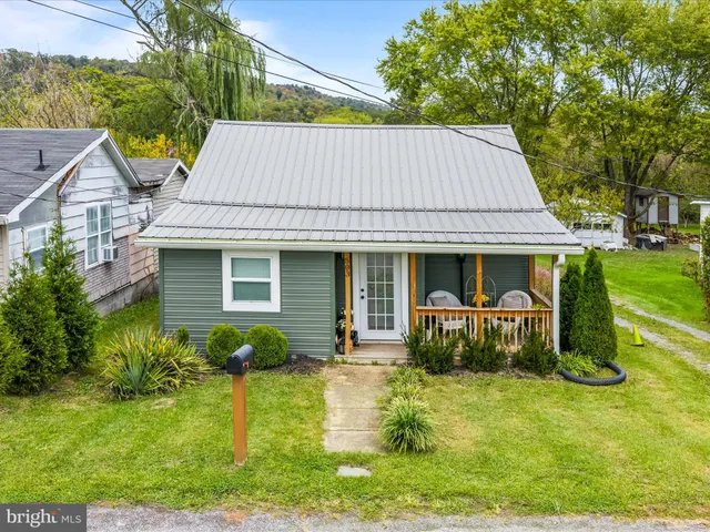 a front view of house with a garden and patio