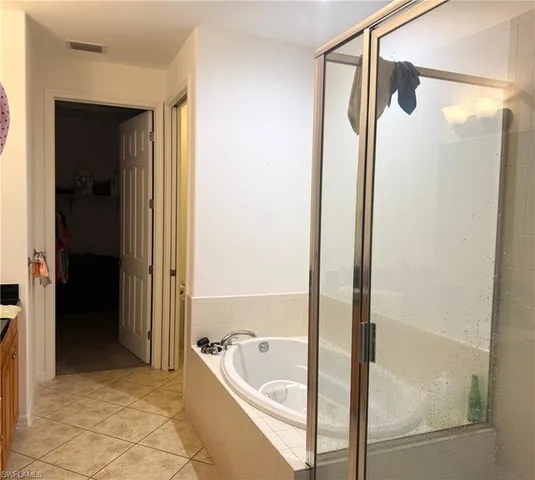 a bathroom with a tub and a shower