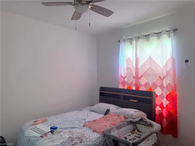 a bedroom with a bed and window