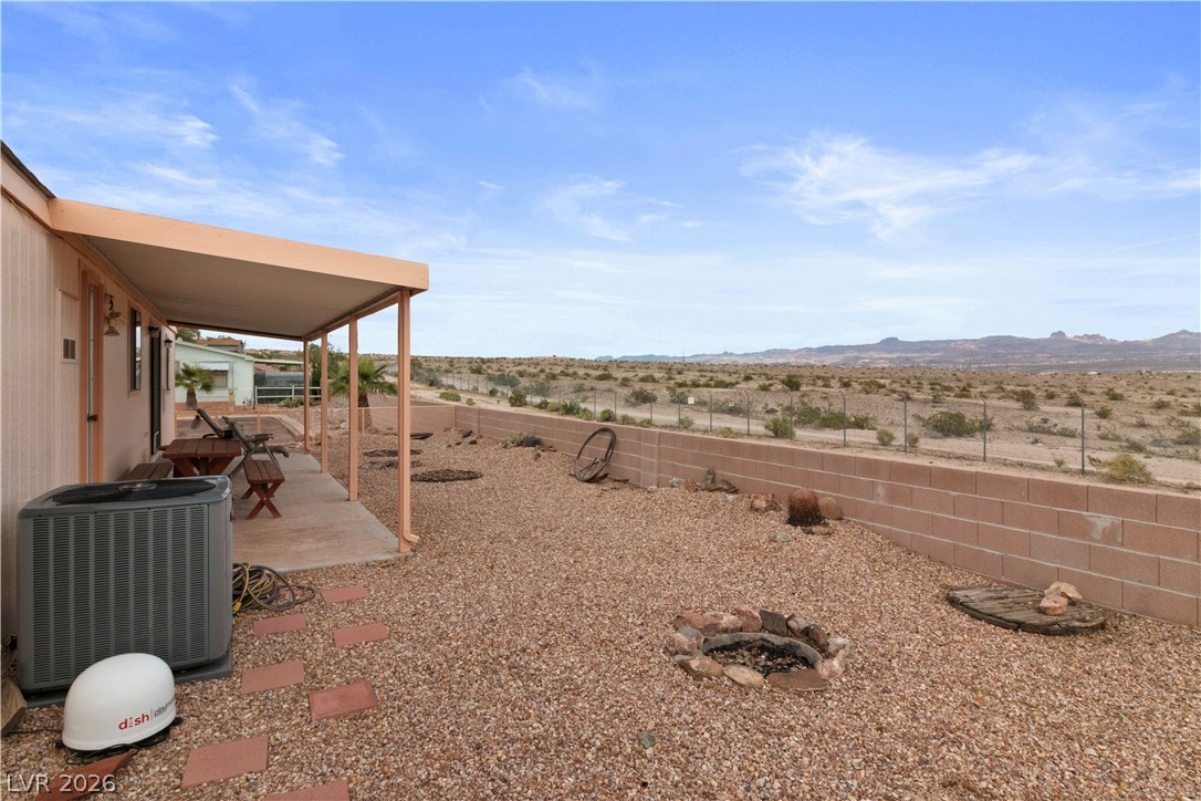 1609 Cajon Court Laughlin, NV 89029 - Photo 39 of 69 Fenced backyard with a patio, a mountain view, a view of countryside, and view of desert