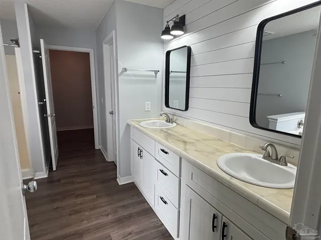 a bathroom with a double vanity sink and a mirror