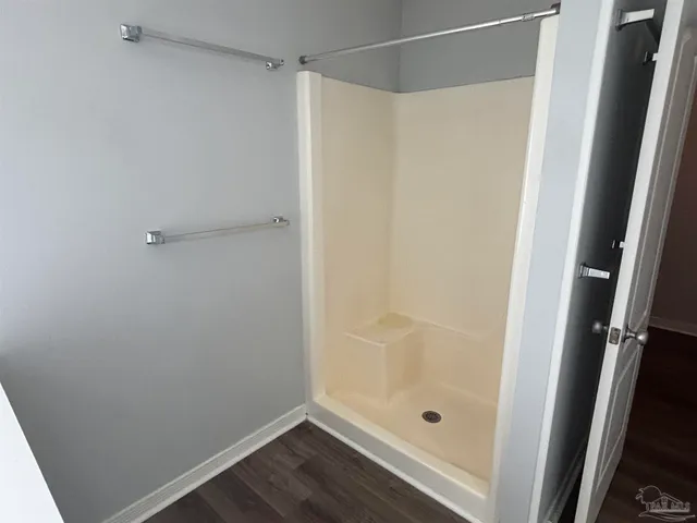 a bathroom with a glass shower door