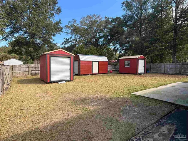 a front view of a house with yard and trees