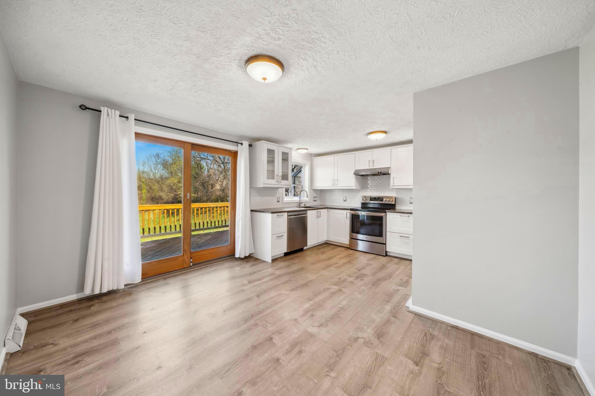 1335 Orchard Way Frederick, MD 21703 - Photo 14 of 42 a view of empty room with wooden floor and windows