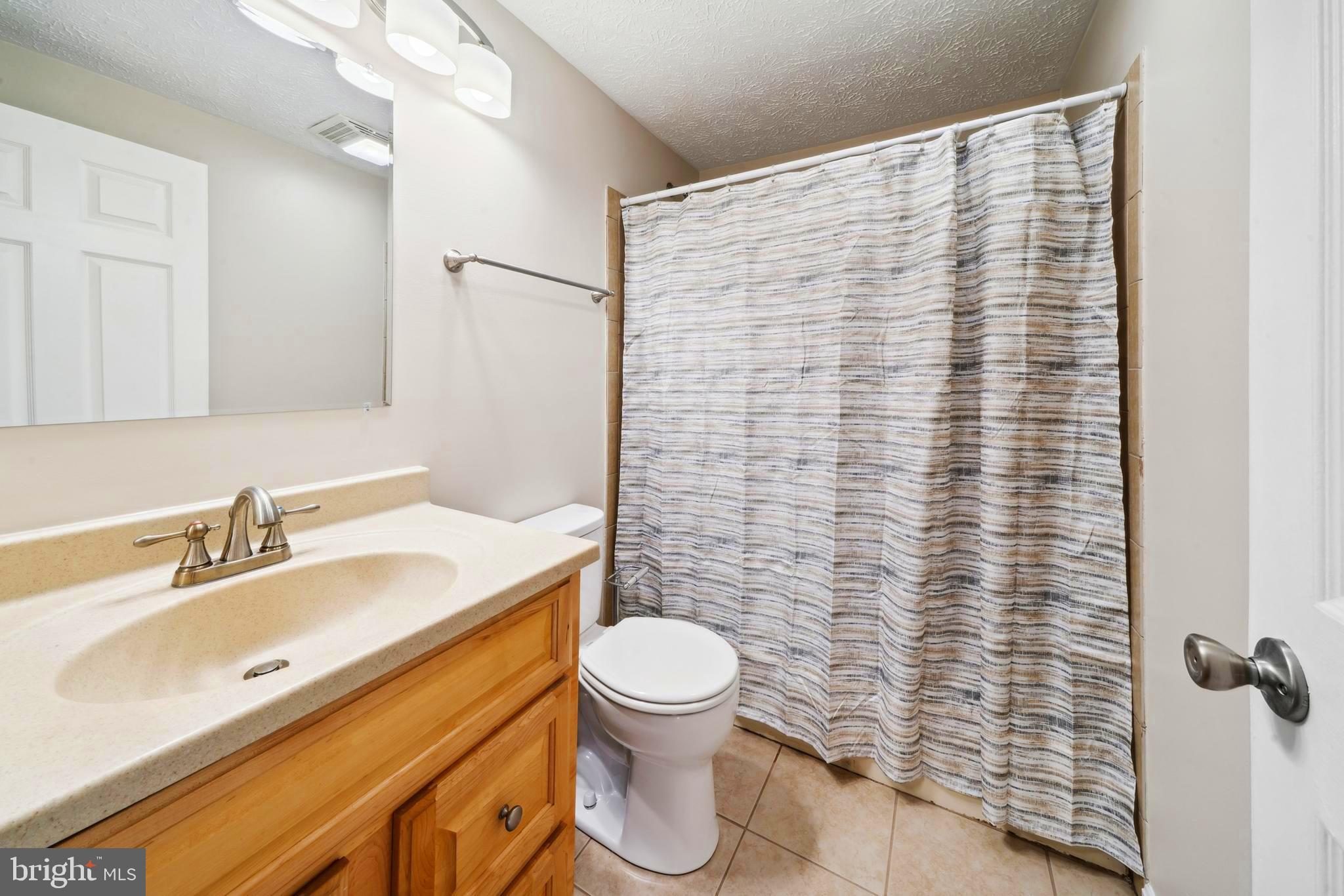 1335 Orchard Way Frederick, MD 21703 - Photo 19 of 42 a bathroom with a sink toilet and shower