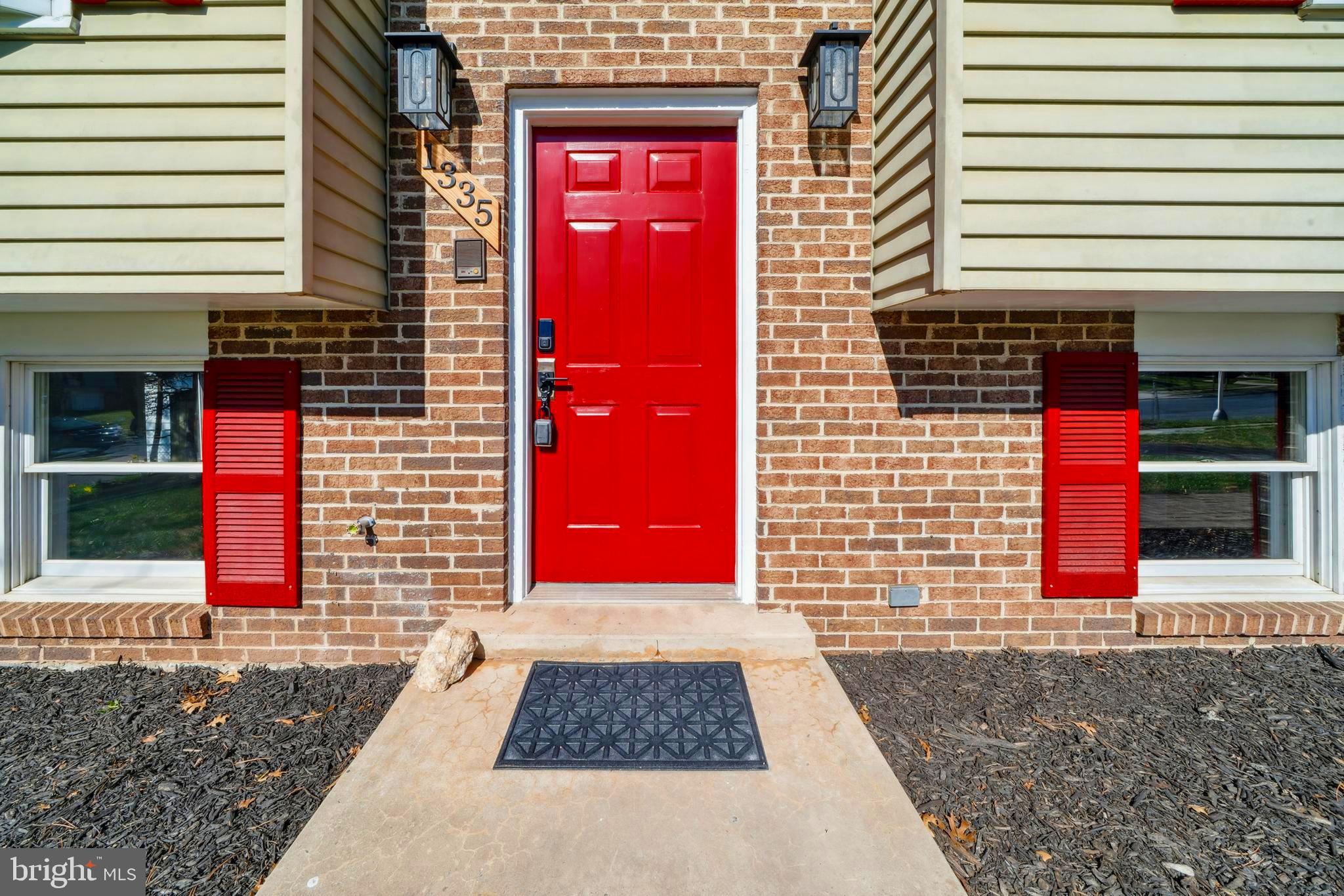 1335 Orchard Way Frederick, MD 21703 - Photo 2 of 42 a view of a brick building with a red door and a window