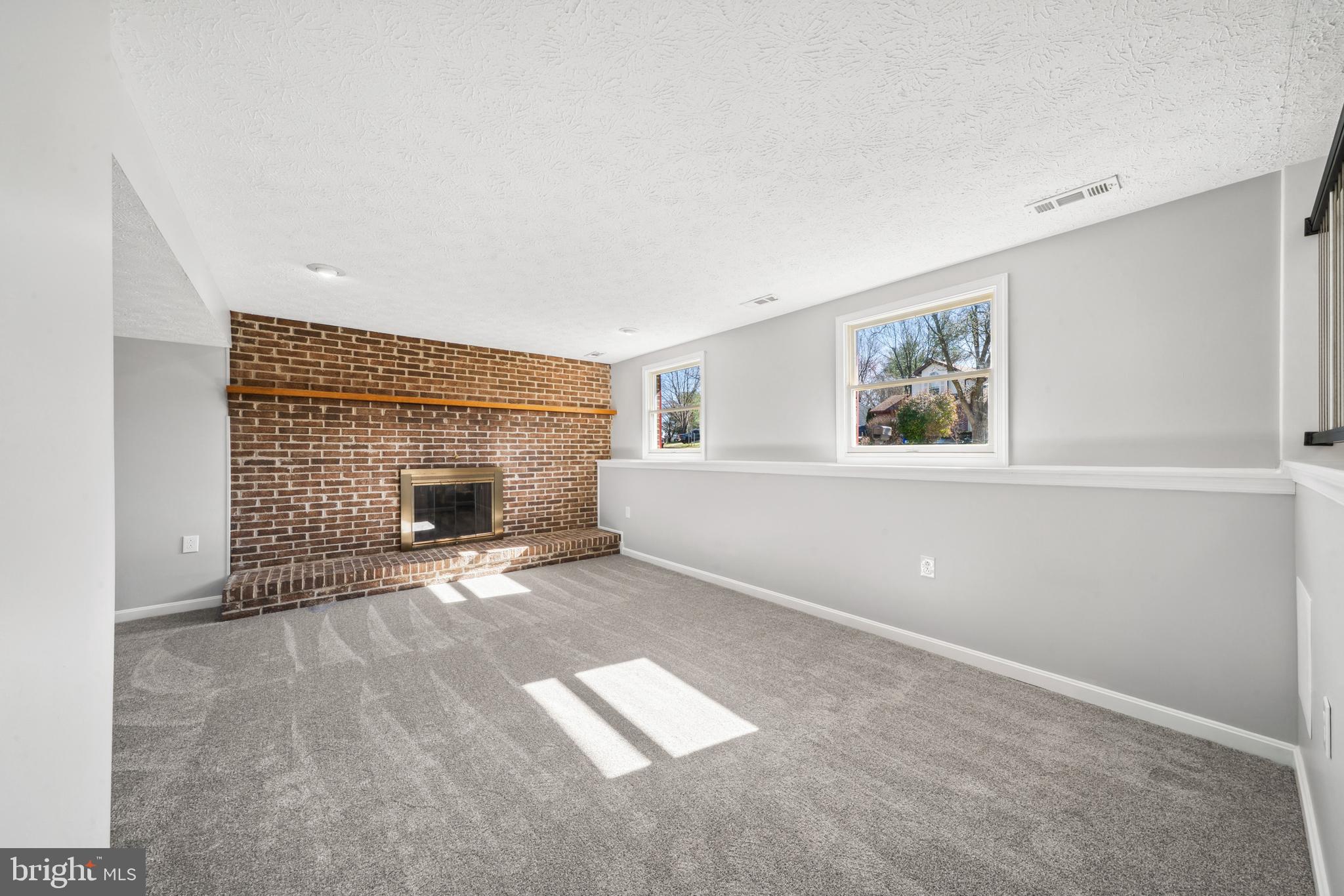 1335 Orchard Way Frederick, MD 21703 - Photo 30 of 42 a view of empty room with windows and fireplace