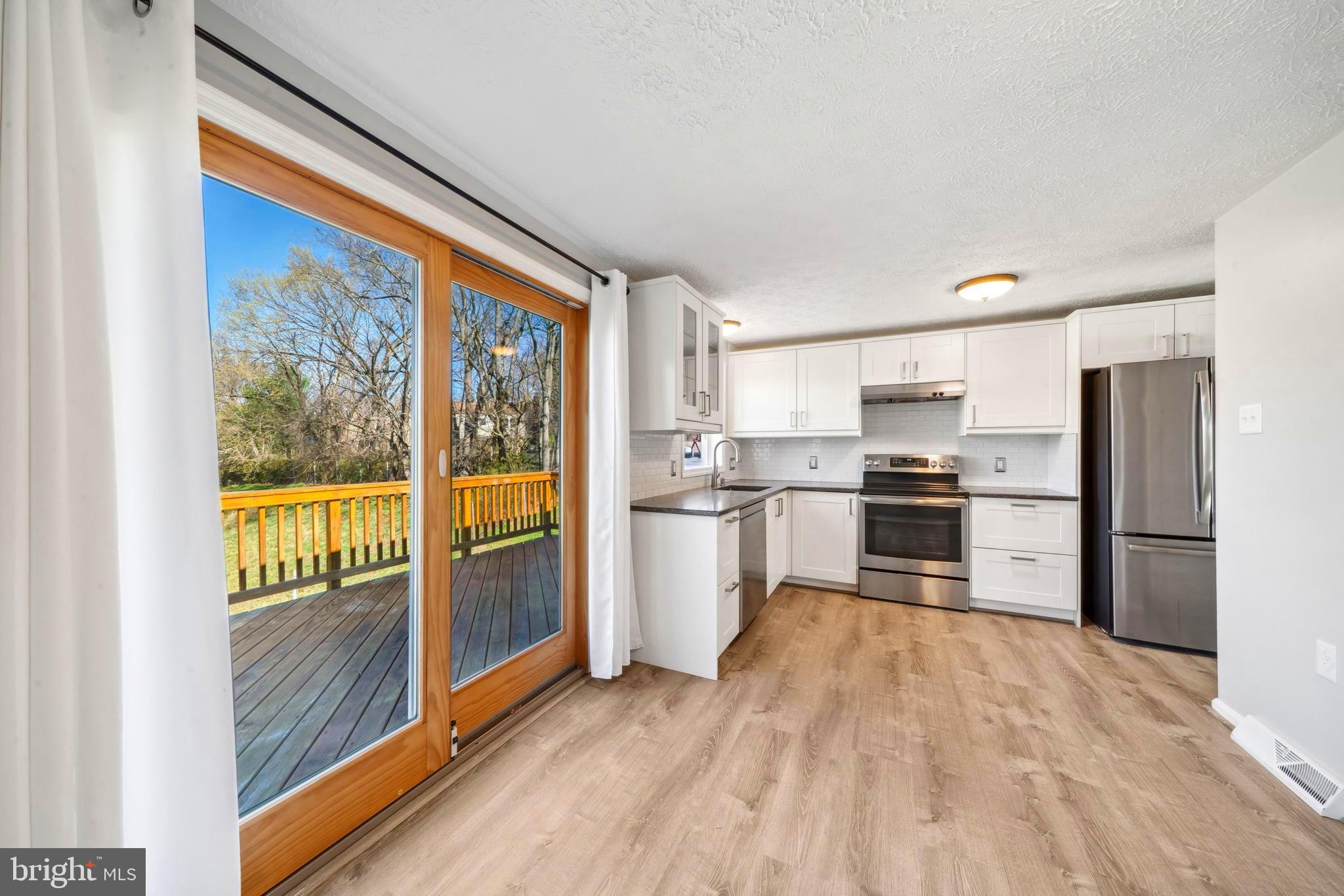 1335 Orchard Way Frederick, MD 21703 - Photo 10 of 42 a kitchen with stainless steel appliances a refrigerator and a stove top oven