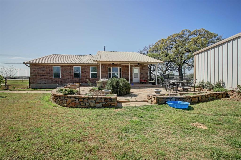 3559 Springfield Road Springtown, TX 76082 - Photo 21 of 37 a front view of a house with sitting area and swimming pool