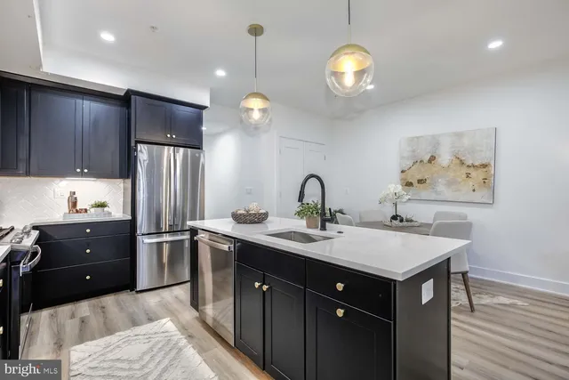 a kitchen with counter top space appliances and cabinets