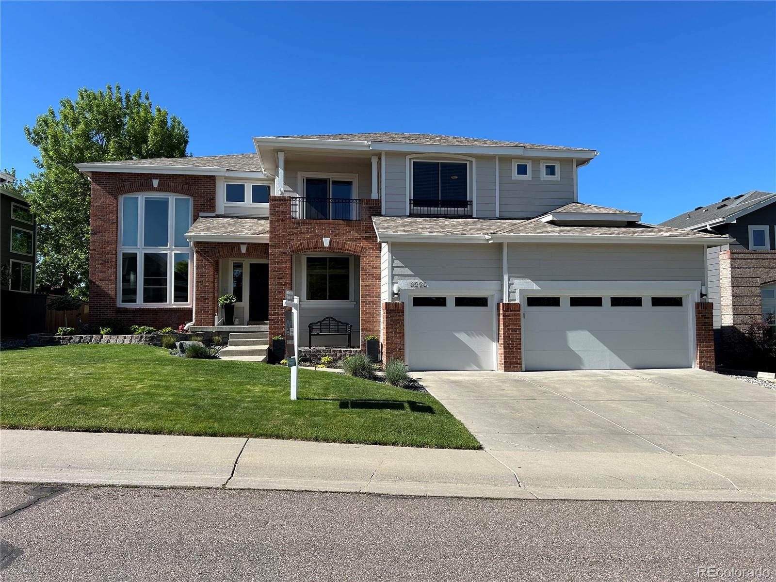 6596 Millstone Street Highlands Ranch, CO 80130 - Photo 1 of 33 a view of a house with a yard and sitting area