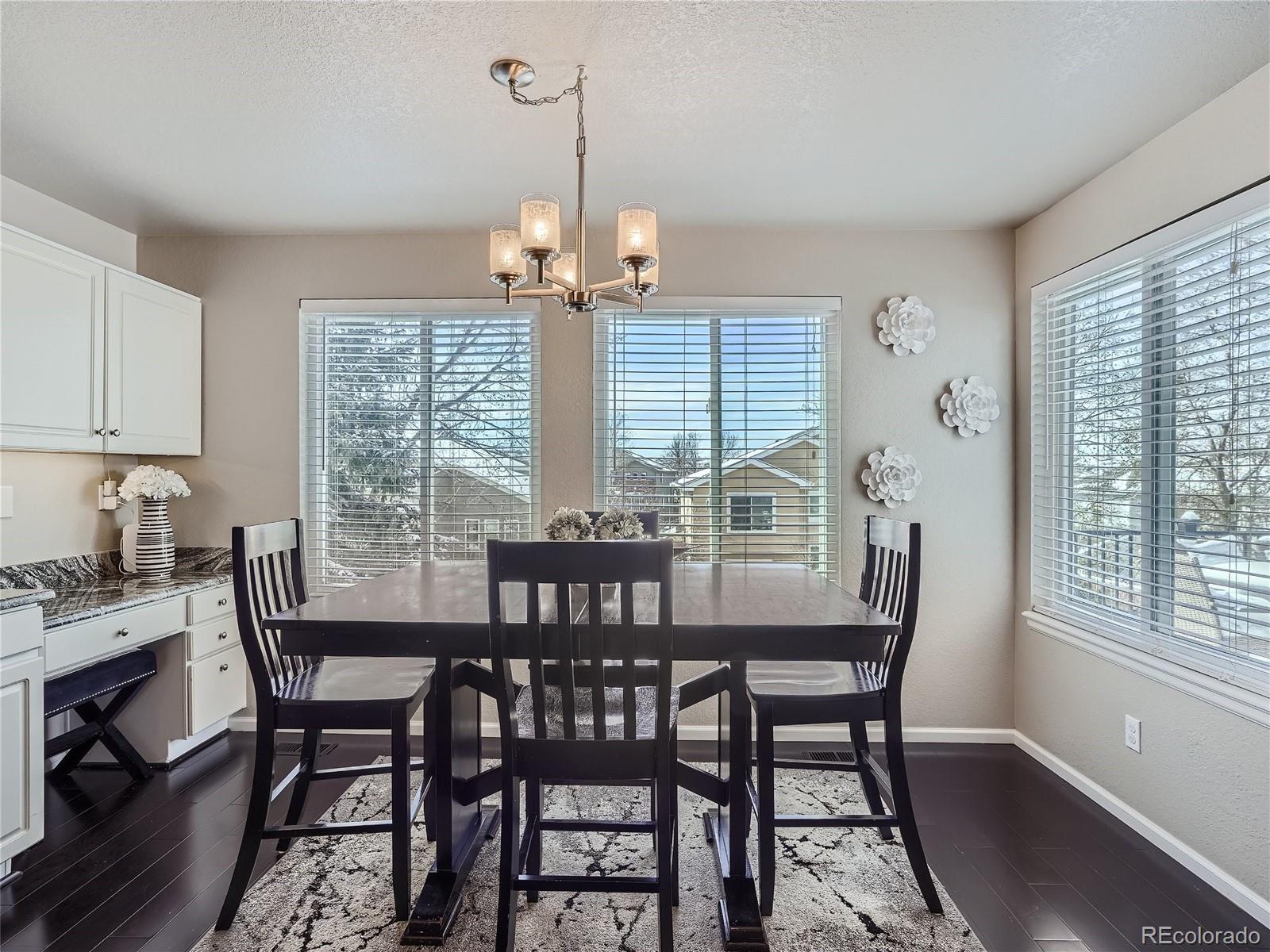 6596 Millstone Street Highlands Ranch, CO 80130 - Photo 12 of 33 a view of a dining room with furniture window and outside view