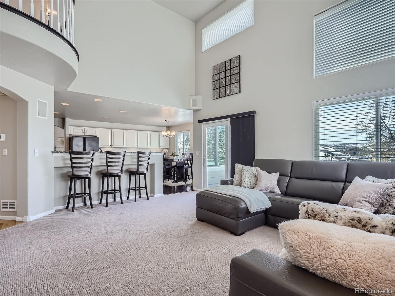 6596 Millstone Street Highlands Ranch, CO 80130 - Photo 14 of 33 a living room with furniture and a ceiling fan