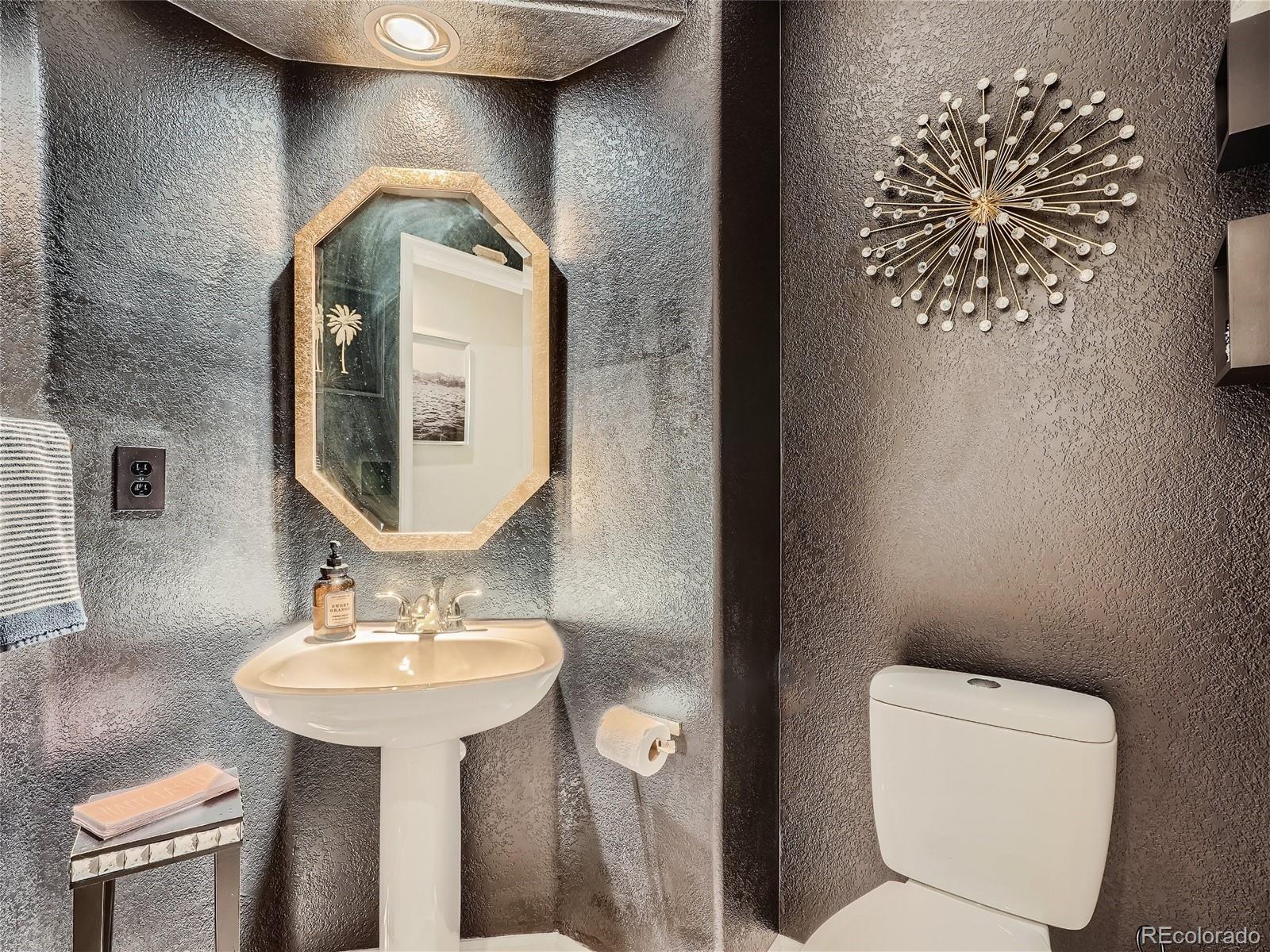 6596 Millstone Street Highlands Ranch, CO 80130 - Photo 15 of 33 a bathroom with a toilet sink and mirror