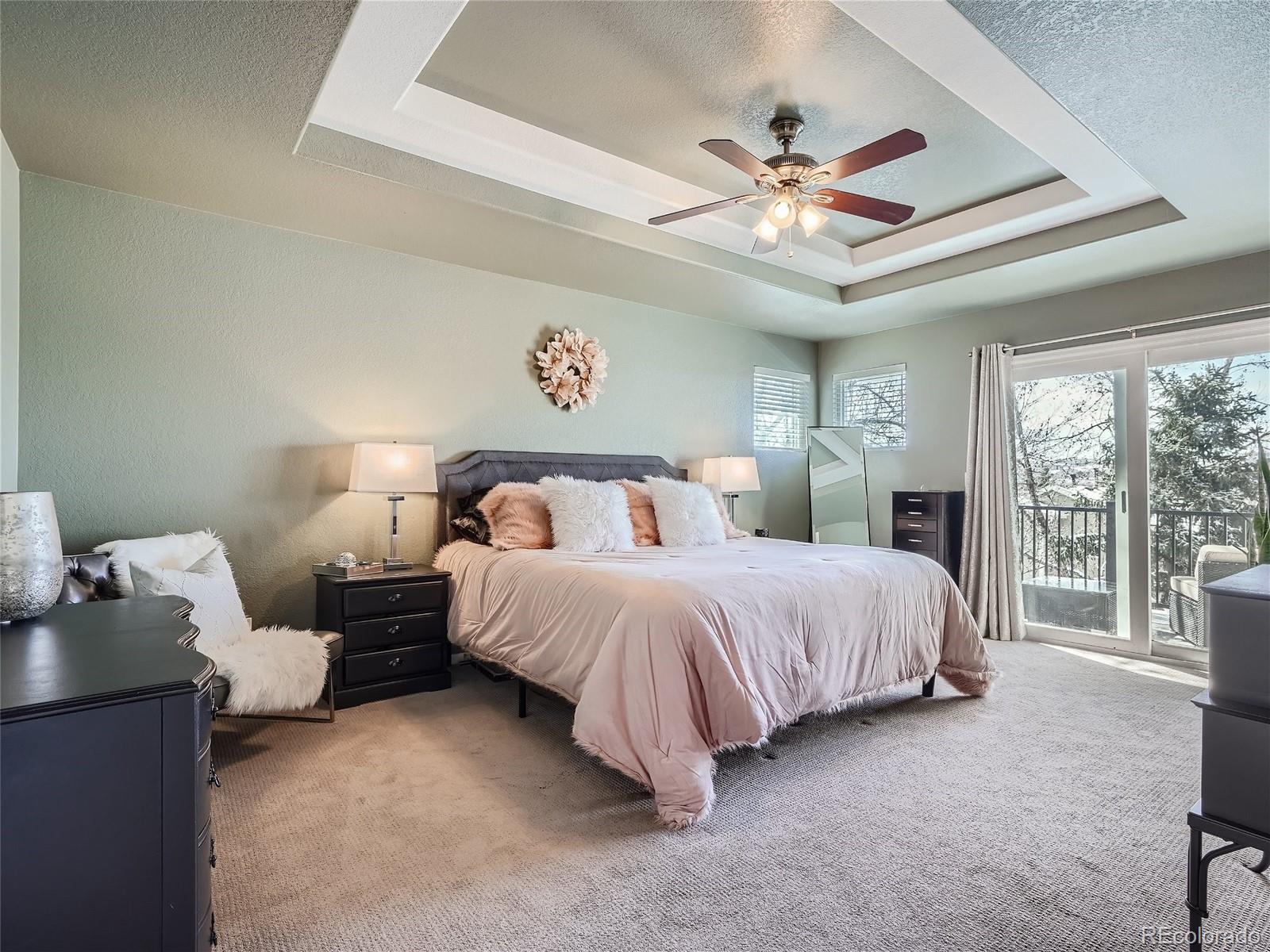 6596 Millstone Street Highlands Ranch, CO 80130 - Photo 16 of 33 a spacious bedroom with a bed and a large window