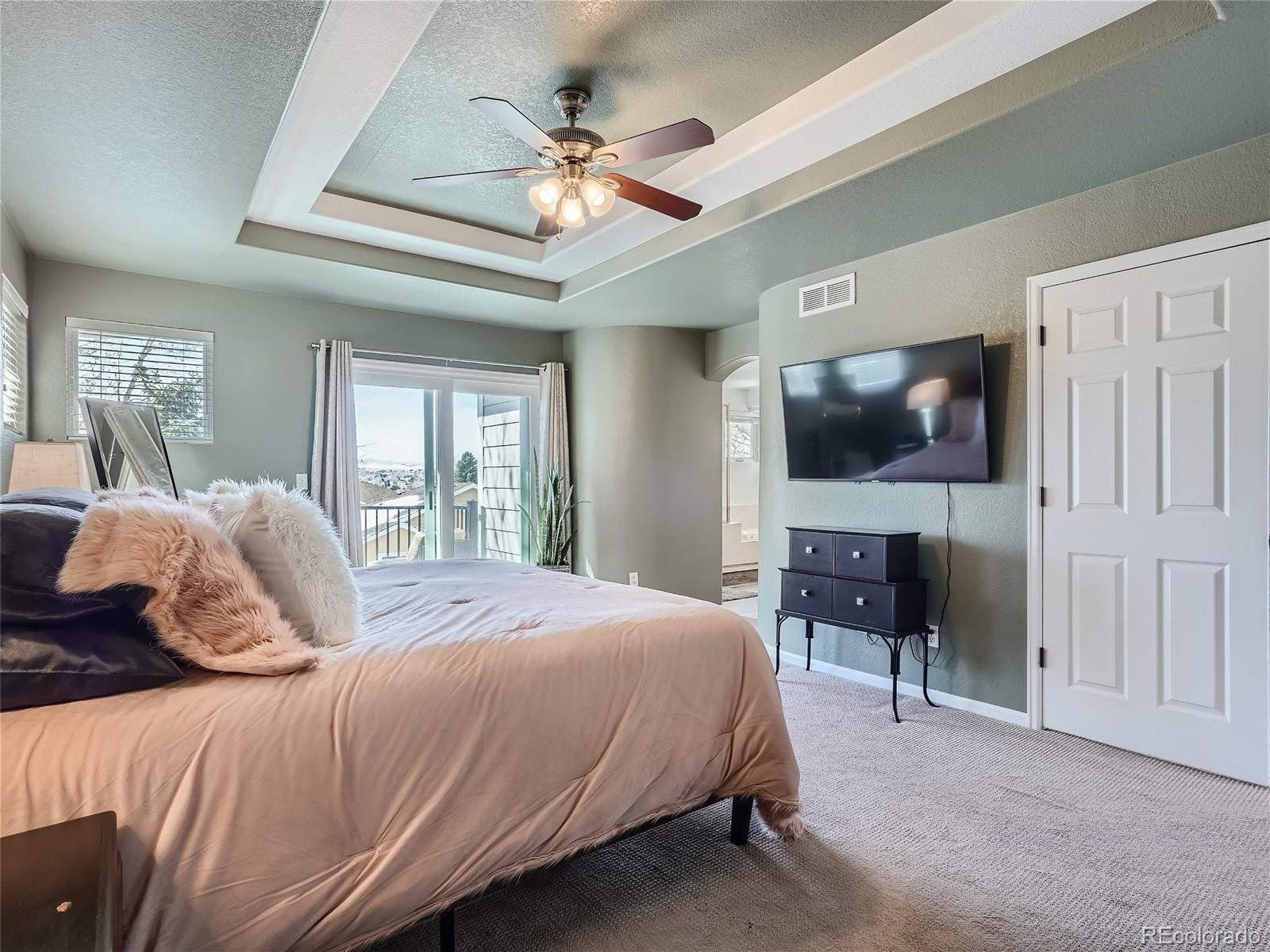 6596 Millstone Street Highlands Ranch, CO 80130 - Photo 17 of 33 a bedroom with a bed and a flat screen tv