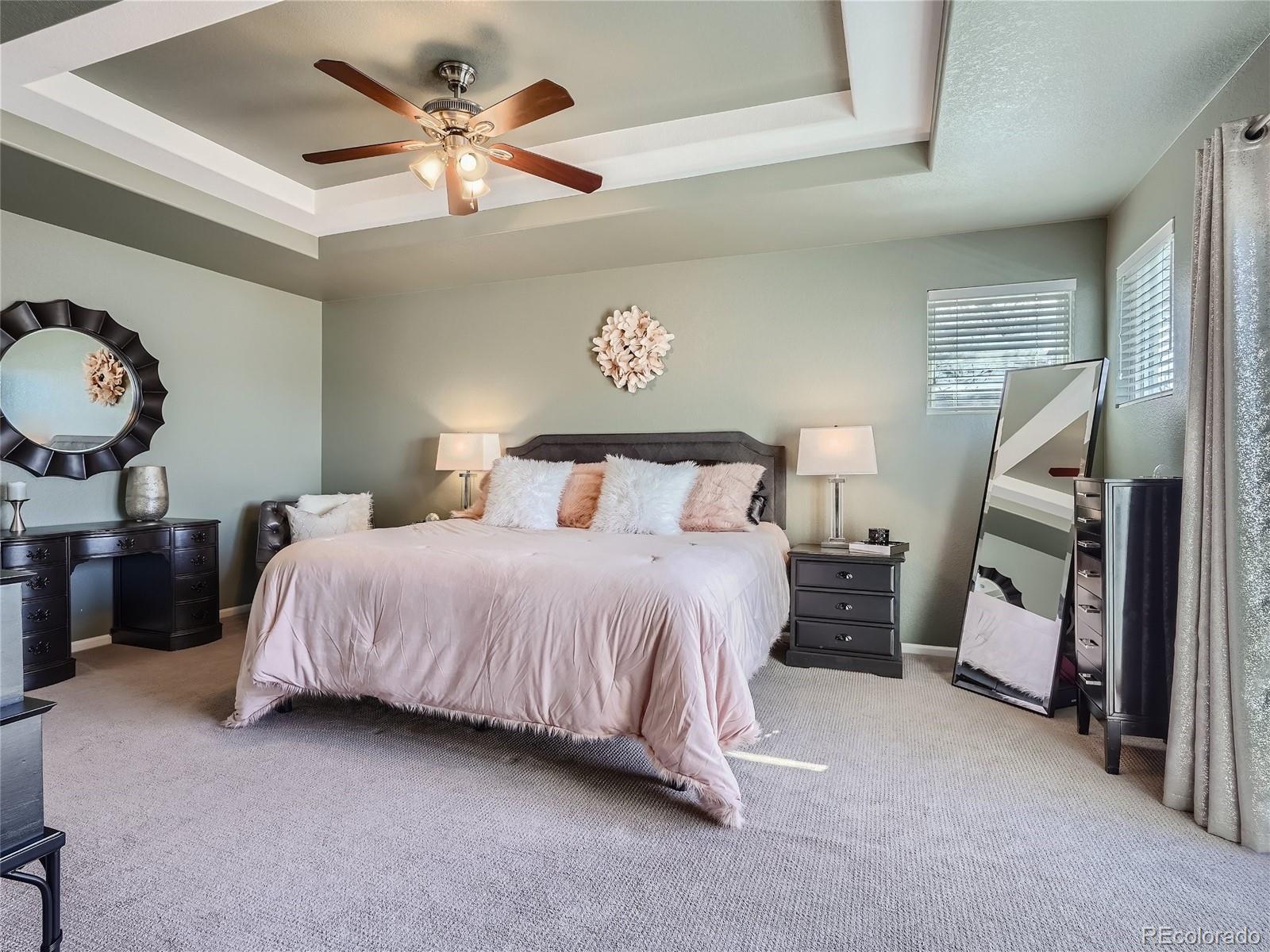 6596 Millstone Street Highlands Ranch, CO 80130 - Photo 18 of 33 a bedroom with a bed and a chandelier
