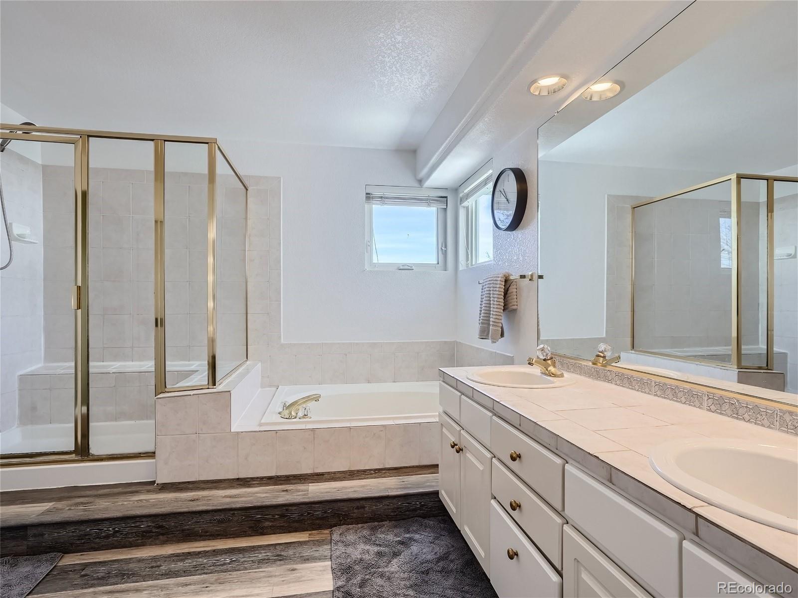6596 Millstone Street Highlands Ranch, CO 80130 - Photo 19 of 33 a bathroom with a bathtub and a sink