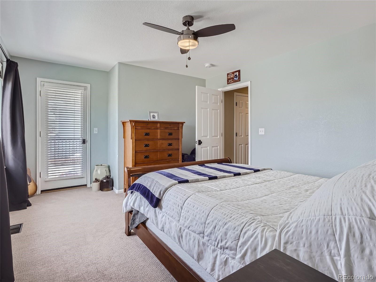6596 Millstone Street Highlands Ranch, CO 80130 - Photo 21 of 33 a bedroom with a bed and a dresser