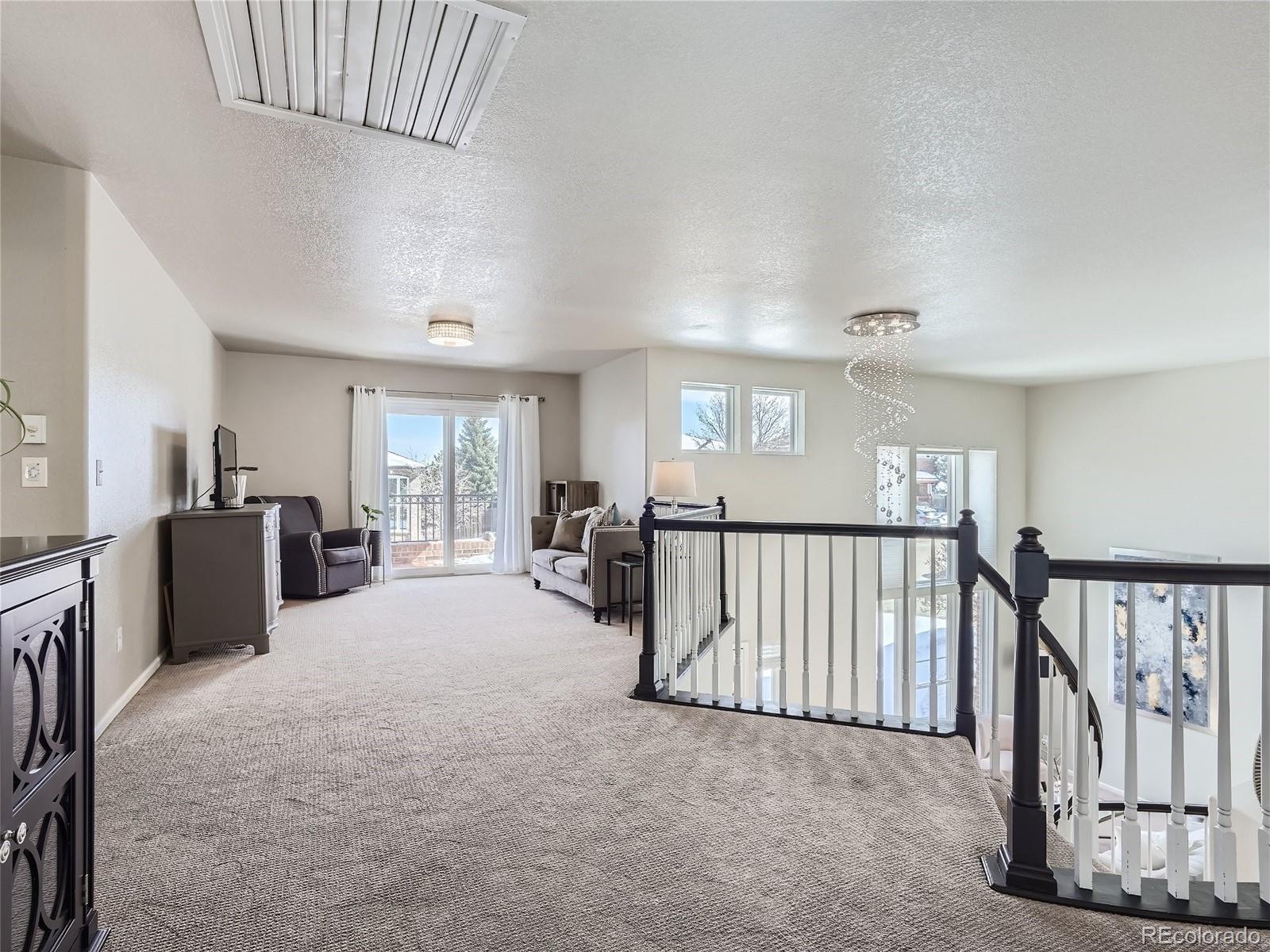 6596 Millstone Street Highlands Ranch, CO 80130 - Photo 24 of 33 a view of a livingroom with furniture and windows