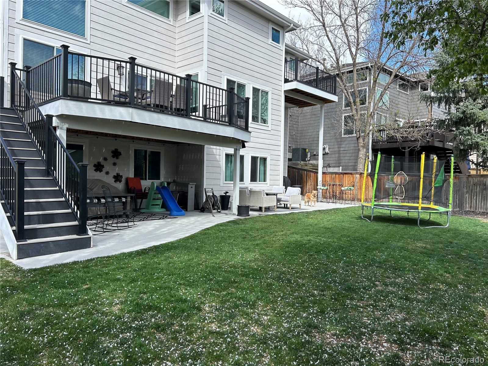 6596 Millstone Street Highlands Ranch, CO 80130 - Photo 28 of 33 a view of a house with a yard and sitting area
