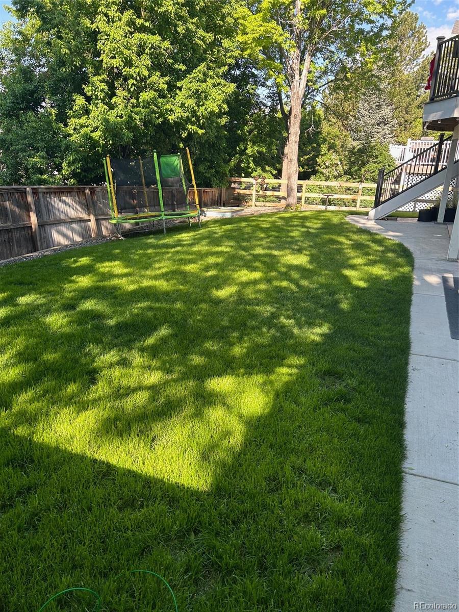 6596 Millstone Street Highlands Ranch, CO 80130 - Photo 29 of 33 a backyard of a house with table and chairs