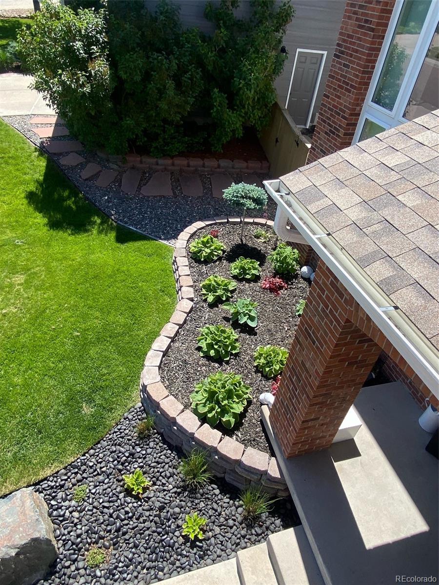 6596 Millstone Street Highlands Ranch, CO 80130 - Photo 32 of 33 a view of a backyard with sitting area