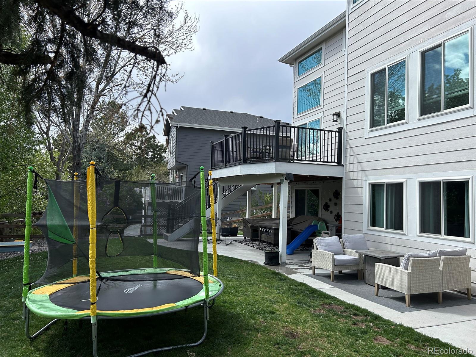 6596 Millstone Street Highlands Ranch, CO 80130 - Photo 33 of 33 a view of a house with backyard swimming pool and sitting area