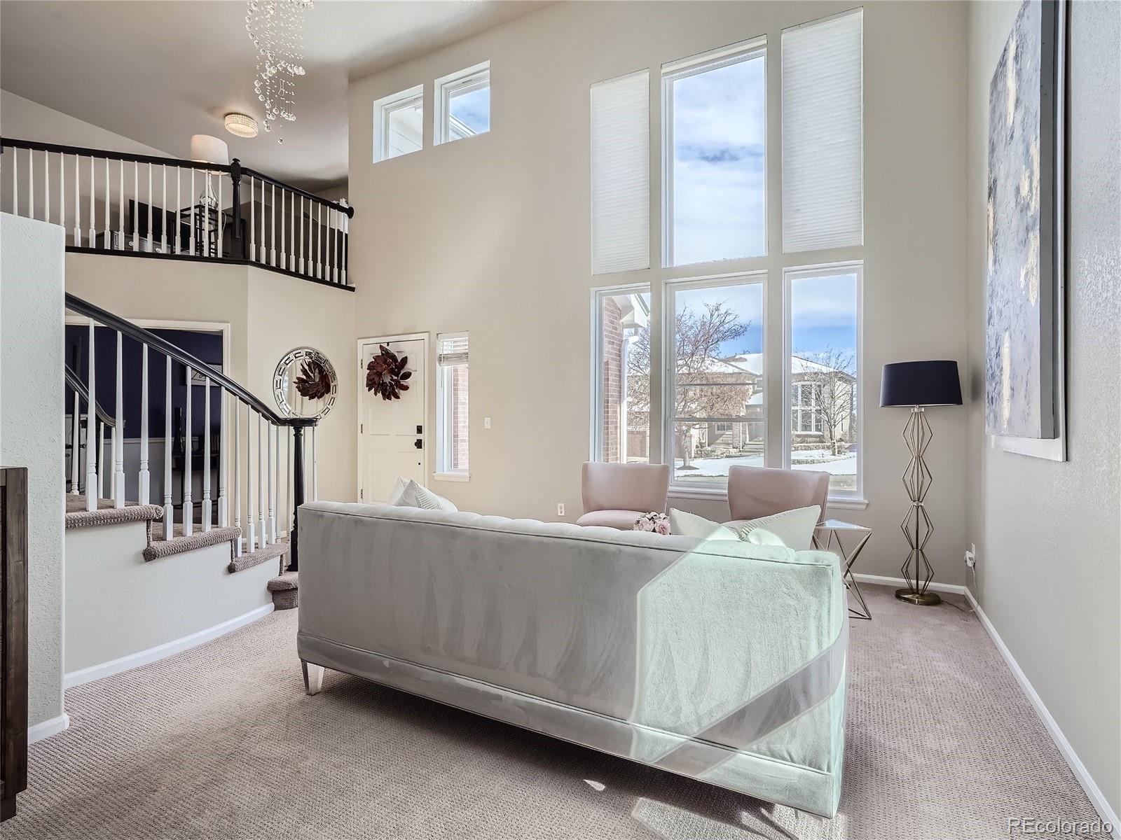 6596 Millstone Street Highlands Ranch, CO 80130 - Photo 5 of 33 a living room with furniture and windows
