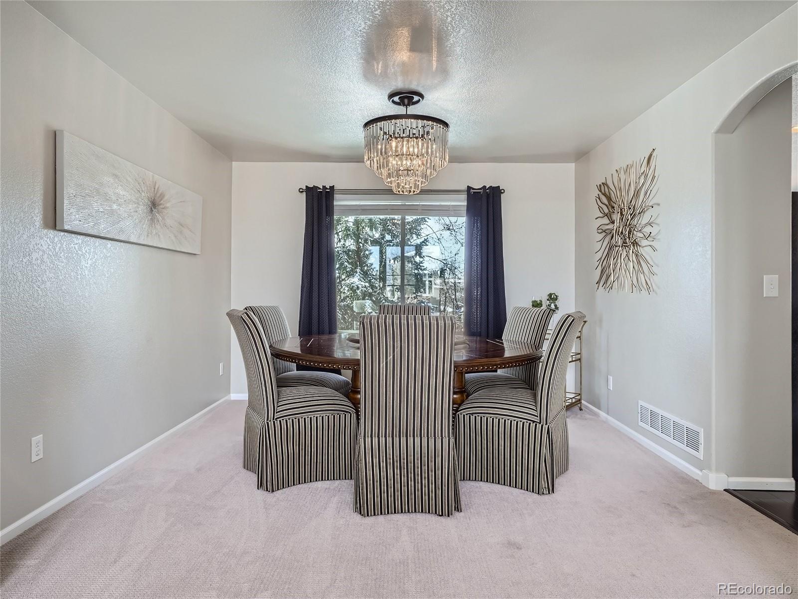 6596 Millstone Street Highlands Ranch, CO 80130 - Photo 7 of 33 a view of a dining room with furniture window and outside view