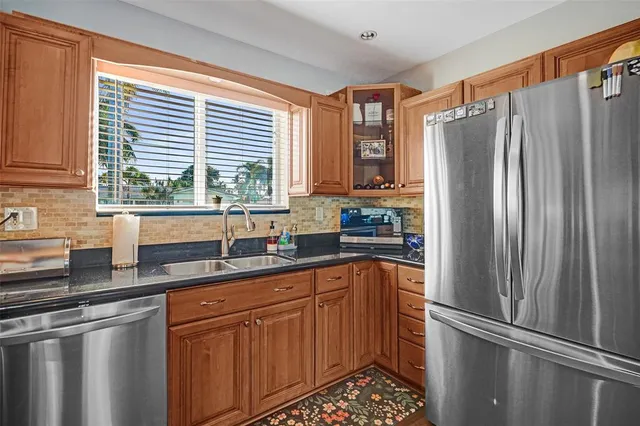 a kitchen with stainless steel appliances a refrigerator and a sink