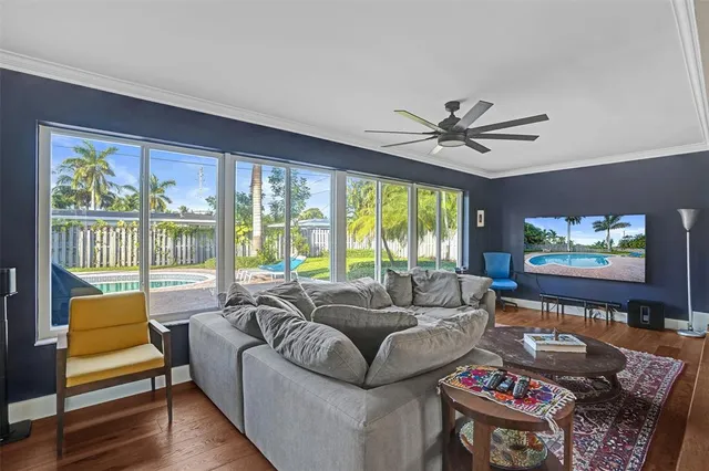 a living room with furniture a large window with outer view
