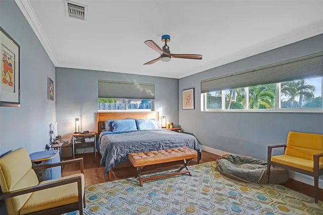 a bedroom with a bed a couch and window