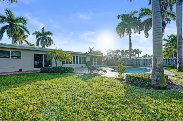 a view of a house with backyard and sitting area